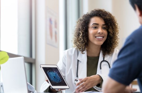 an image of a healthcare worker discussing x-ray scan with patient