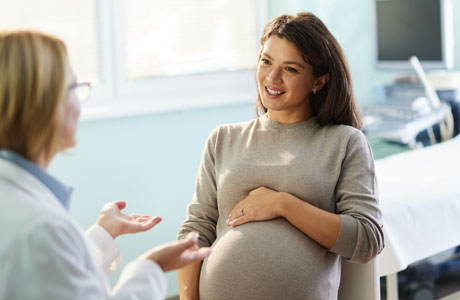 A pregnant woman talking to her doctor